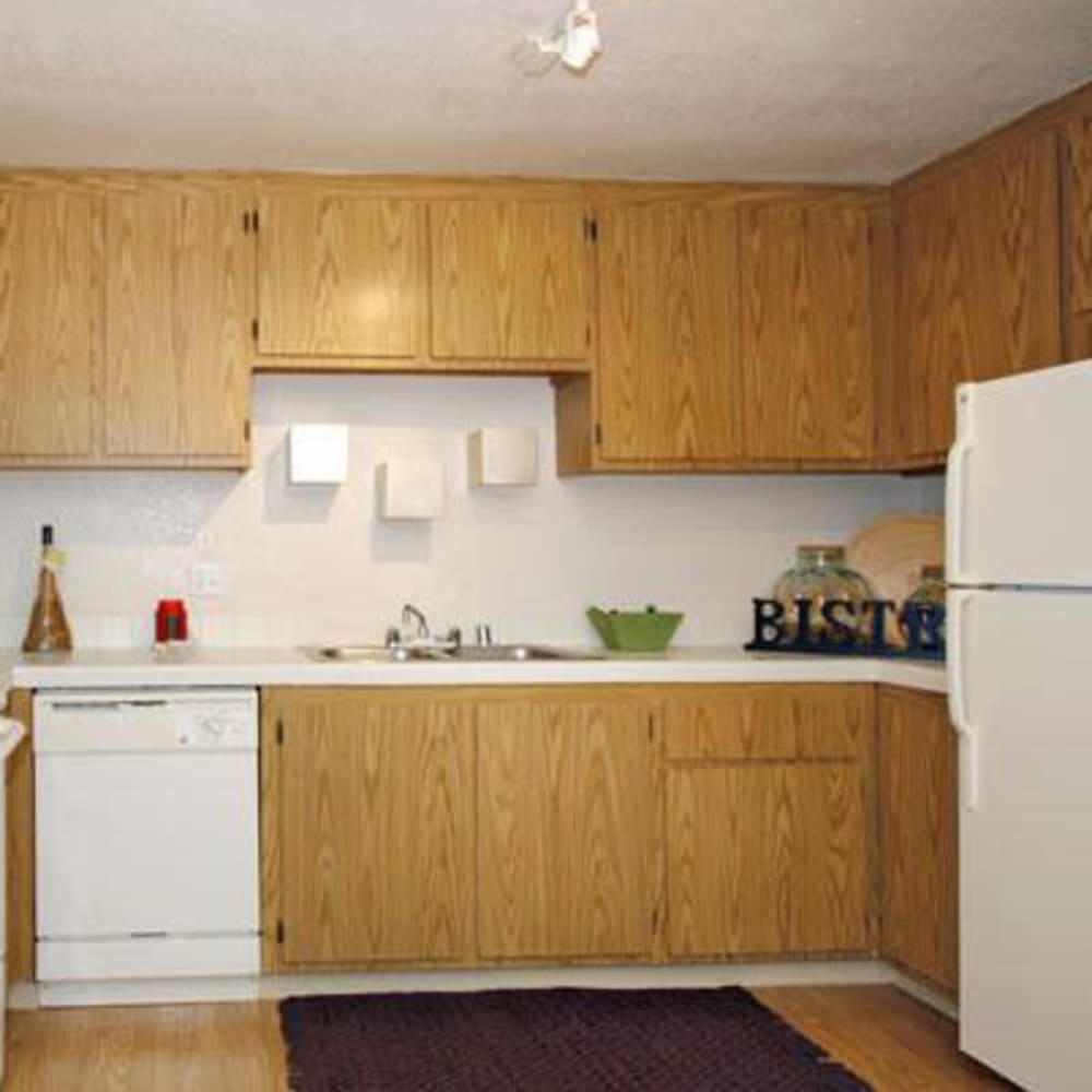 Kitchen with white appliances at Riverstone Apartments in Sacramento, California