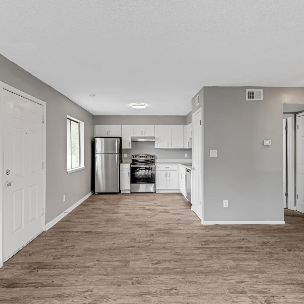 View of hardwood floors and kitchen at The Laurel in Pensacola, Florida