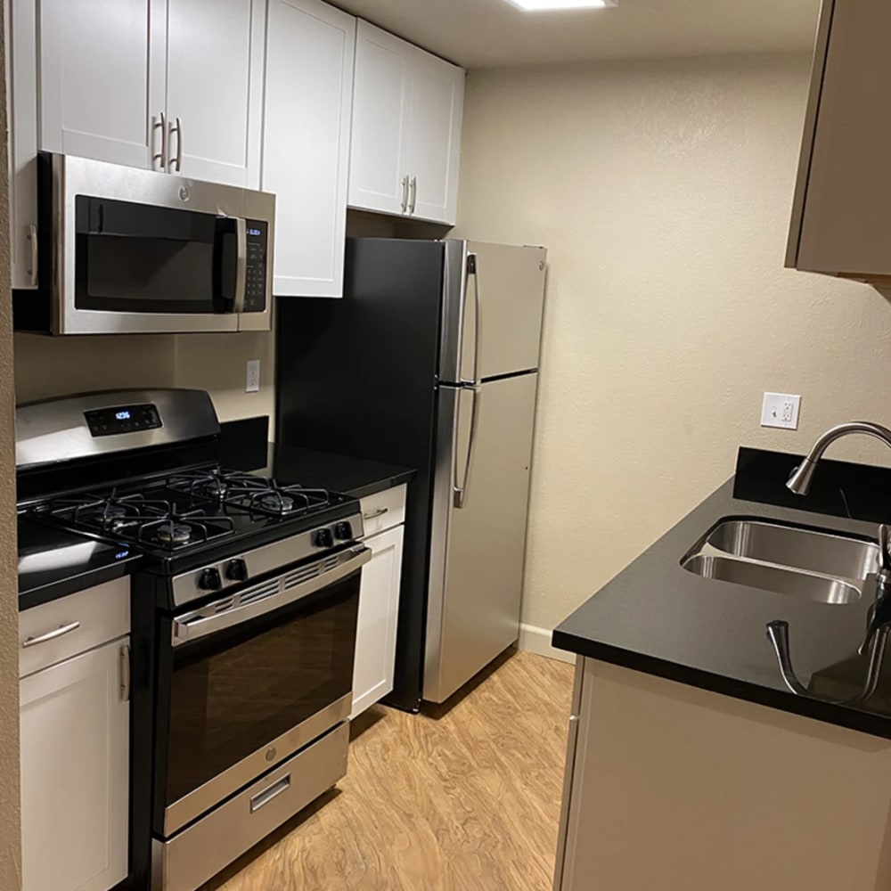 Modern kitchen with stainless-steel appliances at Iron Horse Apartments in Stockton, California