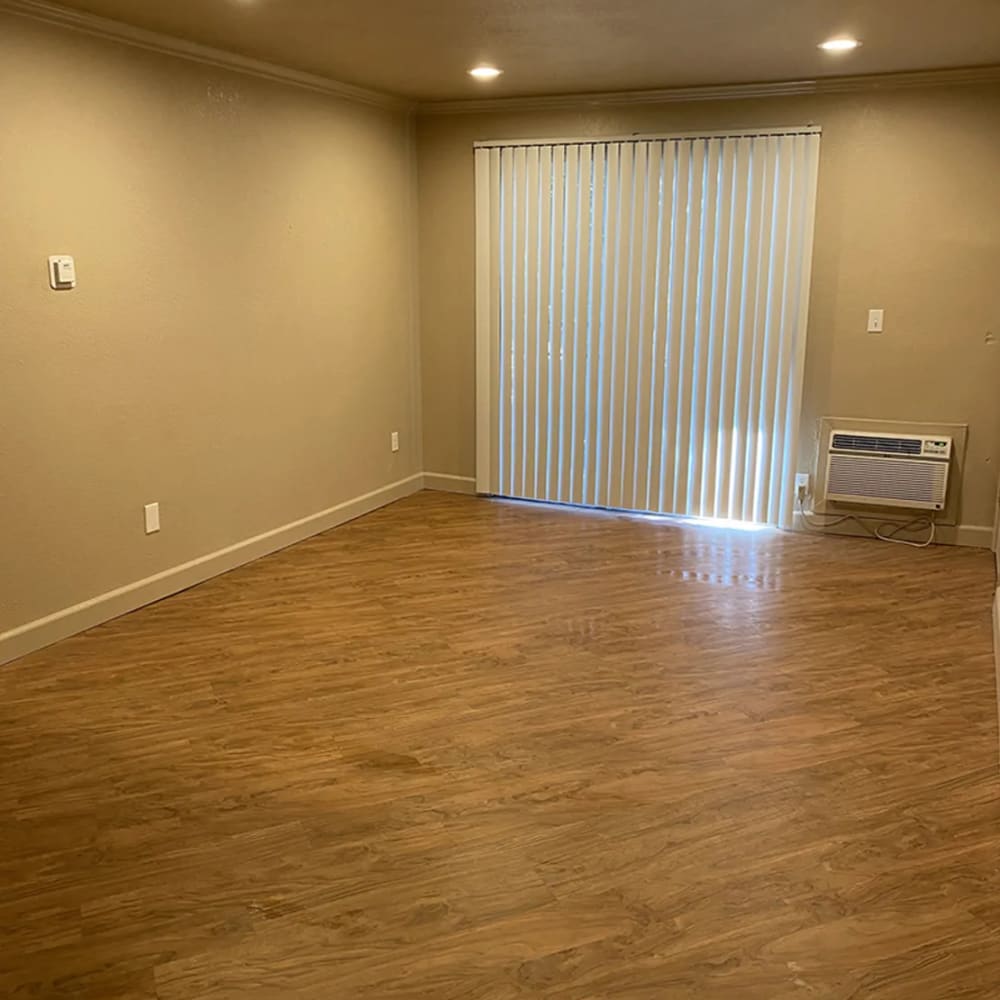 Living room opening onto a private patio at Iron Horse Apartments in Stockton, California