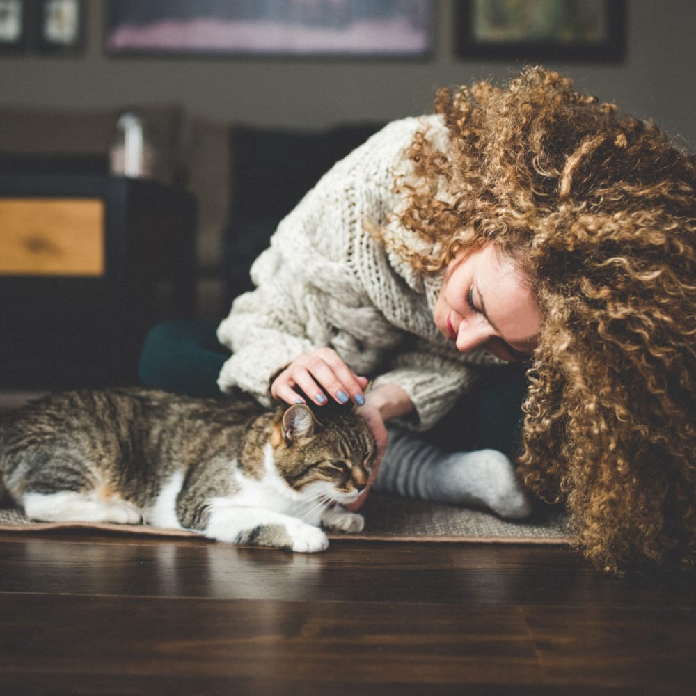 Resident petting her cat in their home at The Cordelia in Fort Walton Beach, Florida