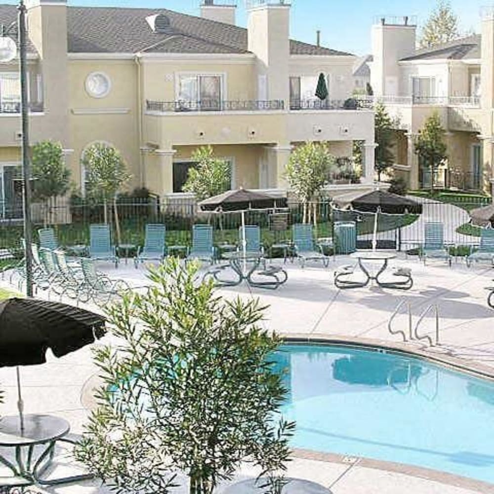 Swimming pool and lounge chairs at Torcello Apartments in Stockton, California