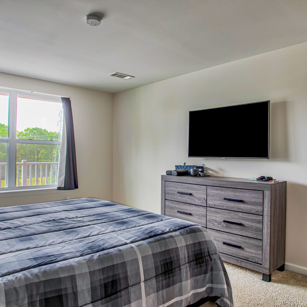 Bedroom with Wall mounted TV at Highland Hills, Cumberland, Rhode Island