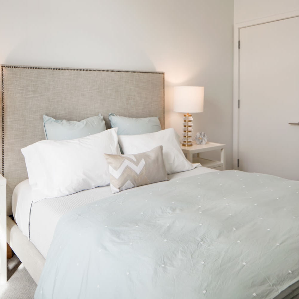 Model bedroom with white sheets at Metro Green Terrace in Stamford, Connecticut