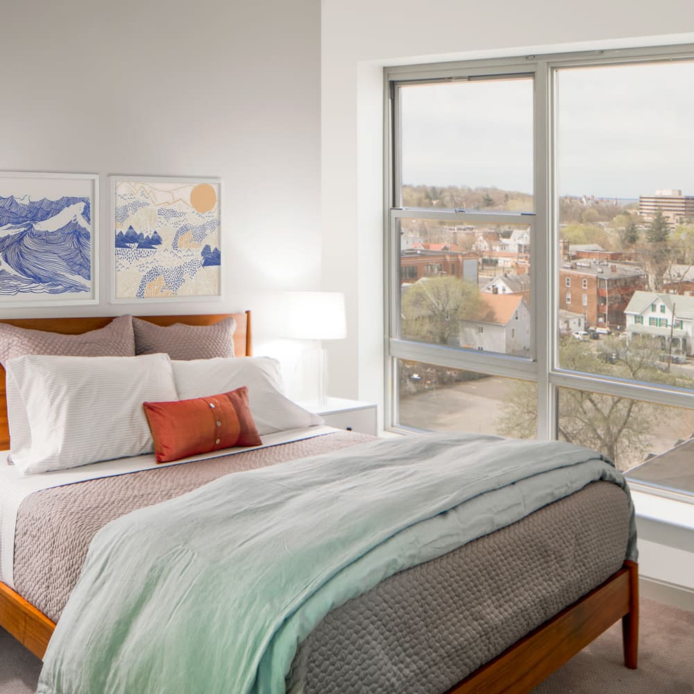 Model bedroom with a large window at Metro Green Terrace in Stamford, Connecticut