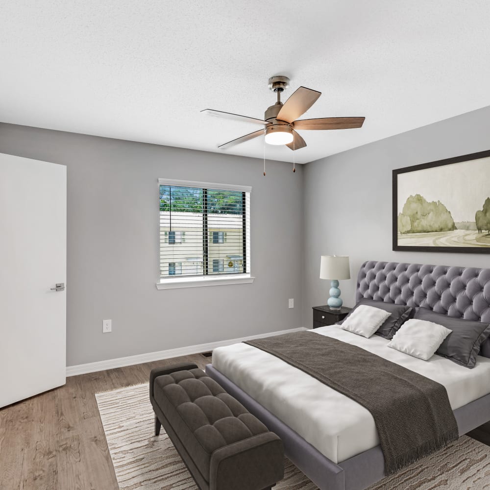A render of a cozy bedroom with ceiling fan in a model home at The Cordelia in Fort Walton Beach, Florida