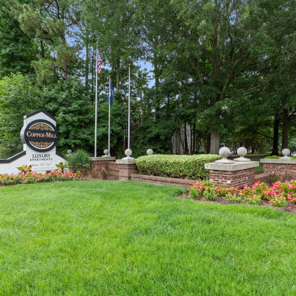 A manicured lawn in front of the main sign at Copper Mill Apartments in Richmond, Virginia