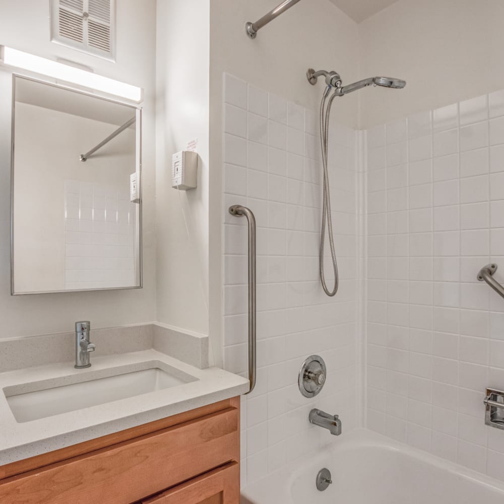 Renovated bathroom with safety grab bars above tub Lakeland Place in Waterford, Michigan