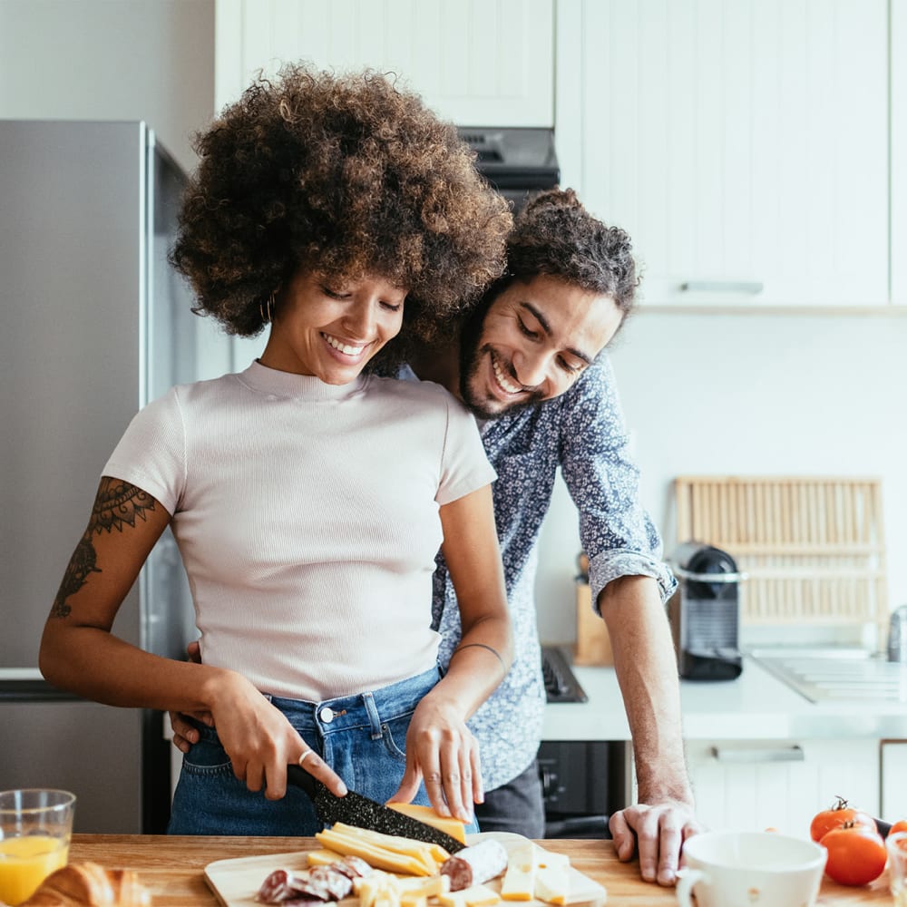 Happy couple cooking at La Pro Apartments in Los Angeles, California
