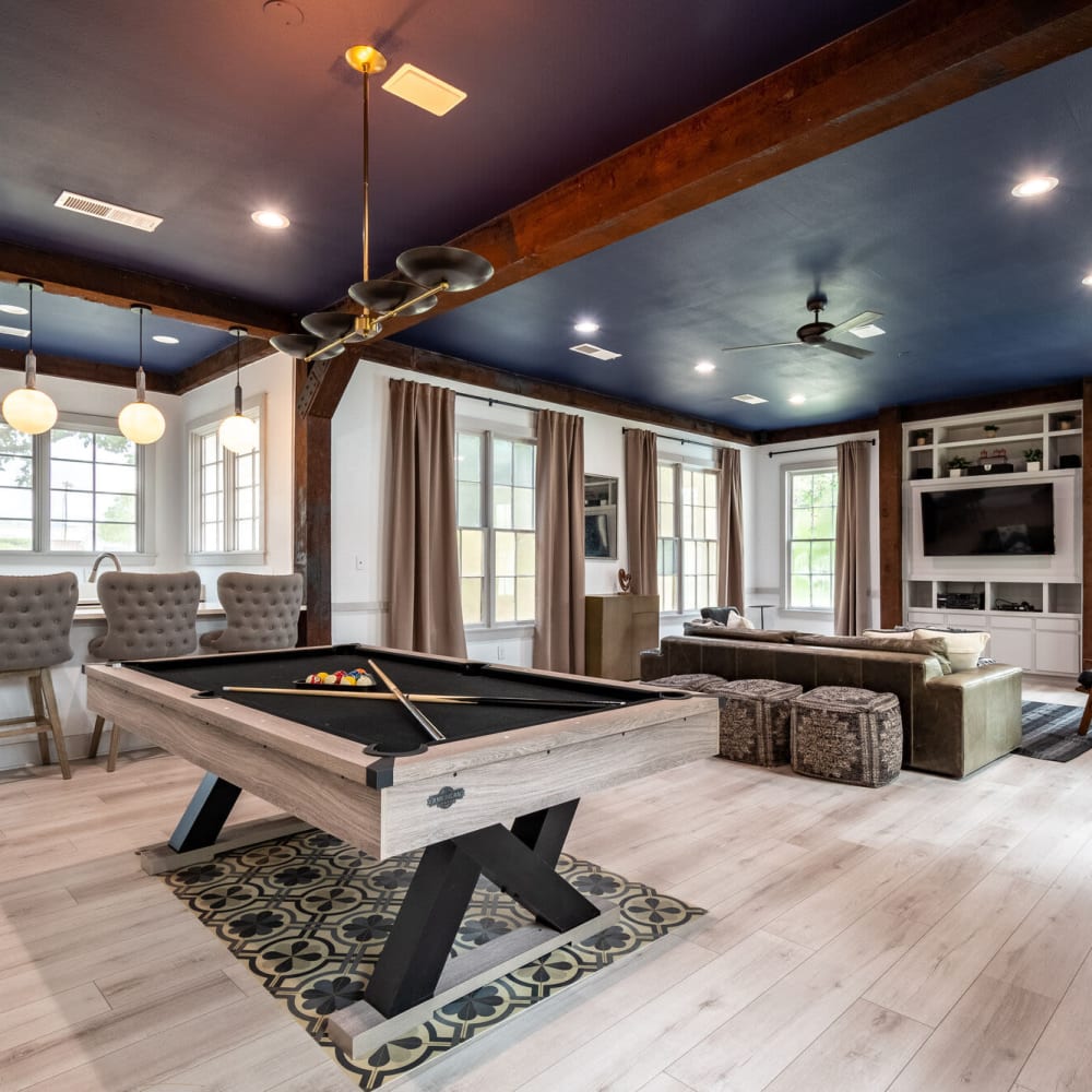 Large open clubhouse with wood-style flooring at Mission Ranch in Mesquite, Texas