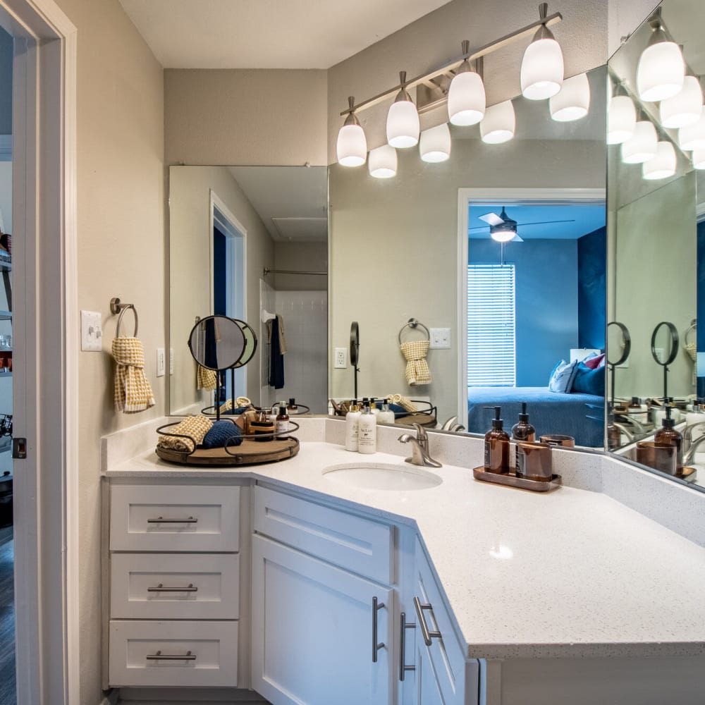 Resident bathroom with ample counter space and lighting at Mission Ranch in Mesquite, Texas