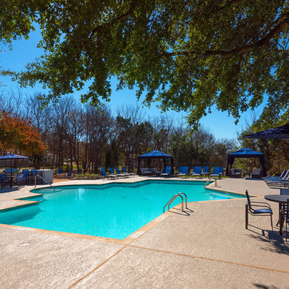 Swimming pool with poolside private cabanas at Ellie Apartments in Austin, Texas