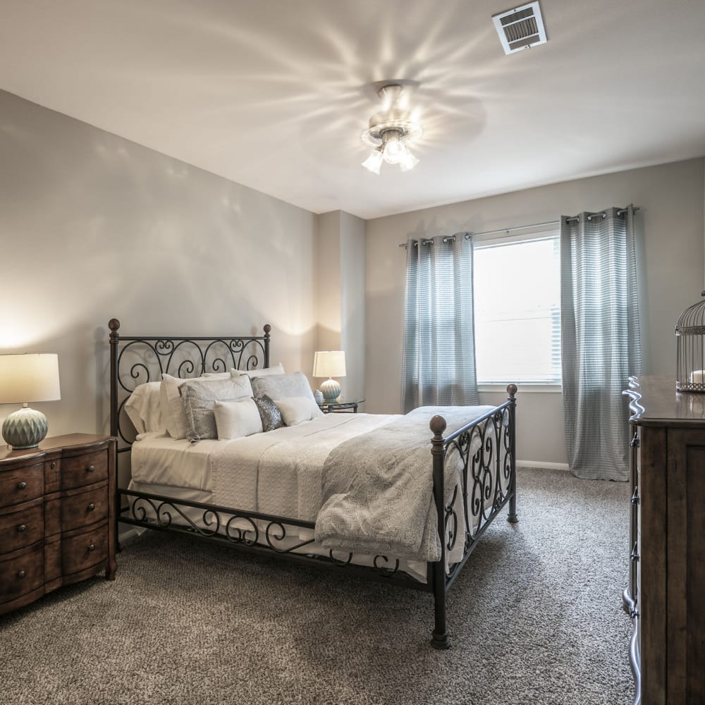 Model bedroom with plush carpeting at Villas at West Road in Houston, Texas