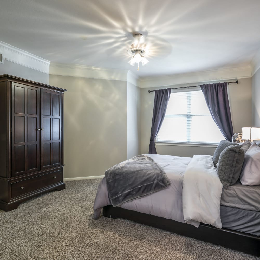 Master bedroom with a ceiling fan at Villas at West Road in Houston, Texas