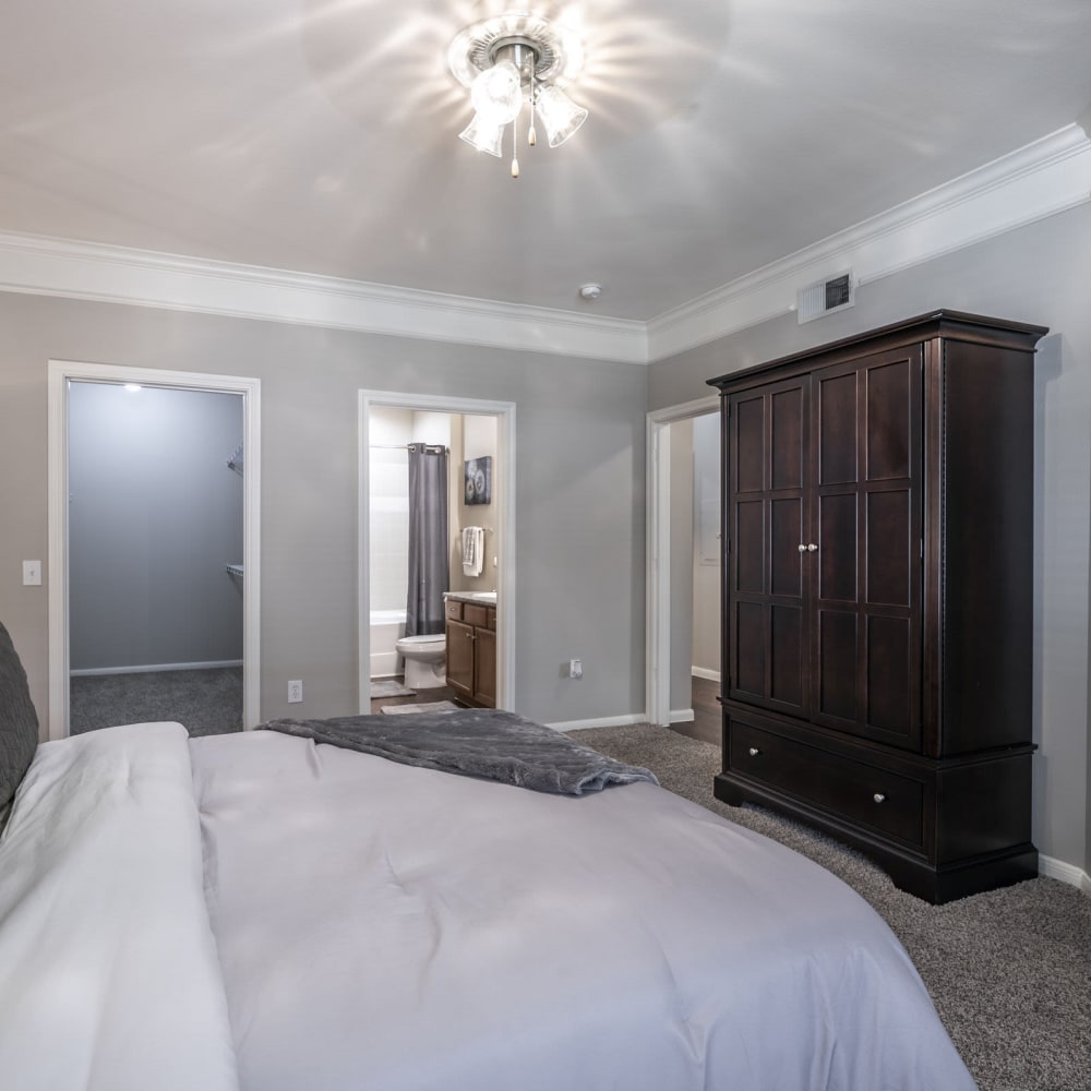 Modern master bedroom with plush carpeting at Villas at West Road in Houston, Texas