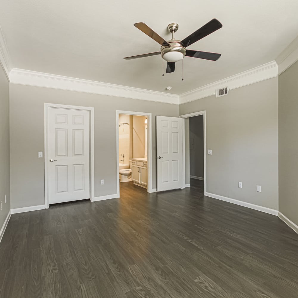 Unfurnished bedroom with great wood-style flooring at Villas at West Road in Houston, Texas