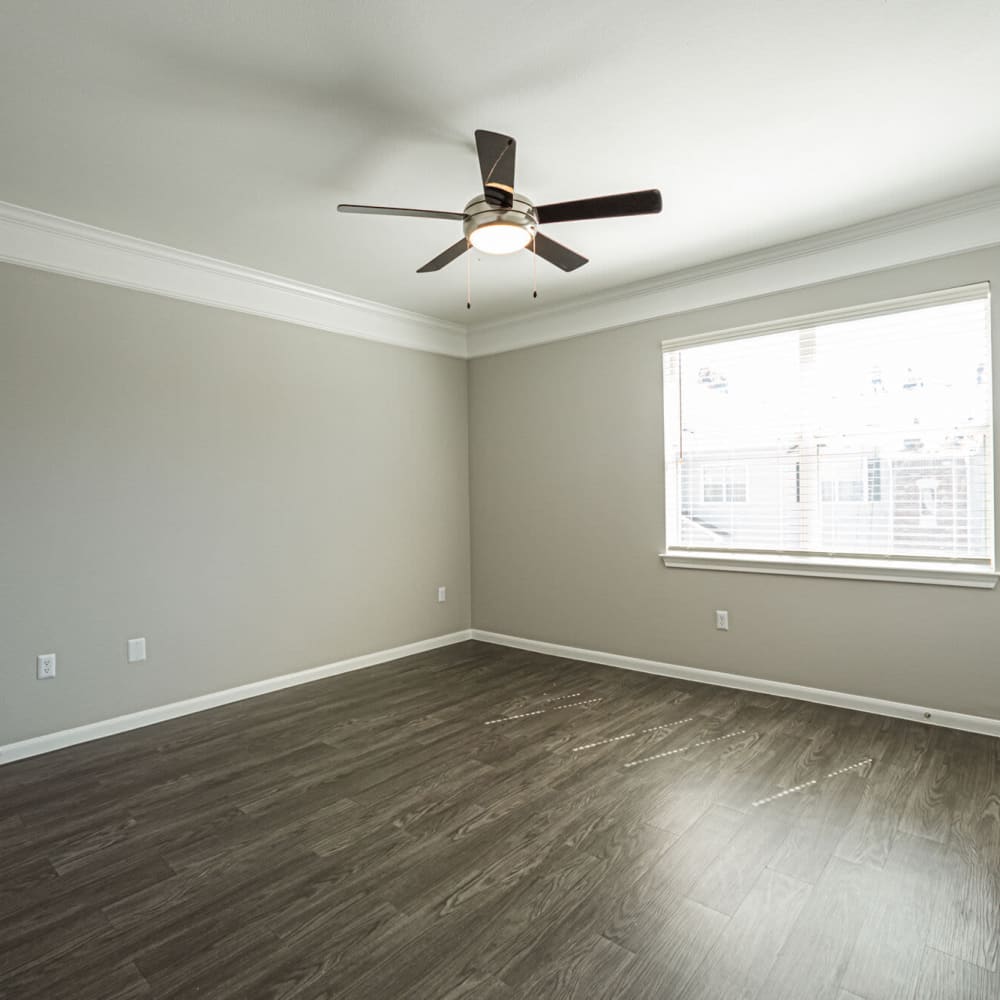 Unfurnished bedroom with a ceiling fan at Villas at West Road in Houston, Texas