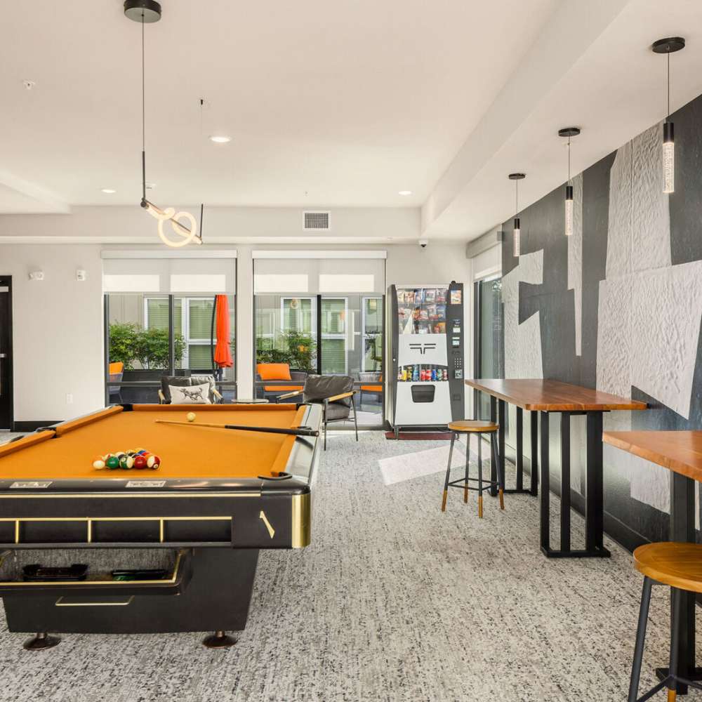 Club house with a pool table and setting area at Sixth & Alder Apartments in Tacoma, Washington