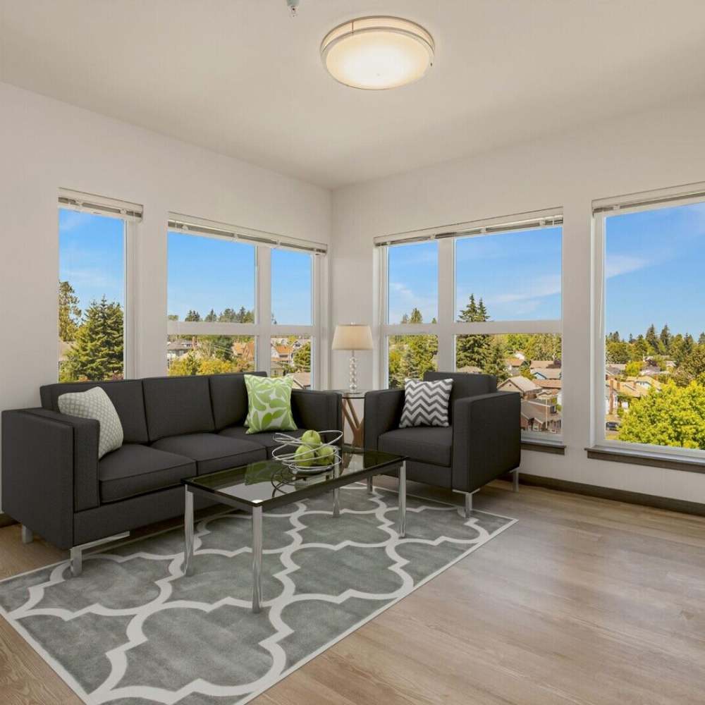Spacious living room with couch, coffee table at Sixth & Alder Apartments in Tacoma, Washington