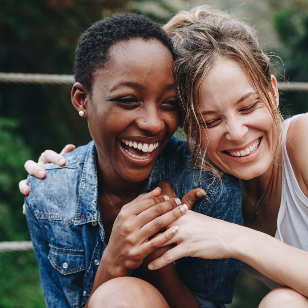 Friends hugging at Courtyard Apartments in Stockton, California