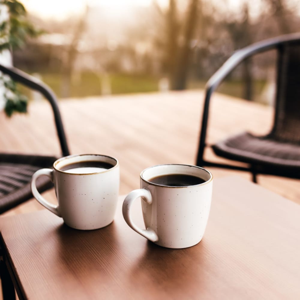 Mugs off coffee on a table outside at Courtyard Apartments in Stockton, California