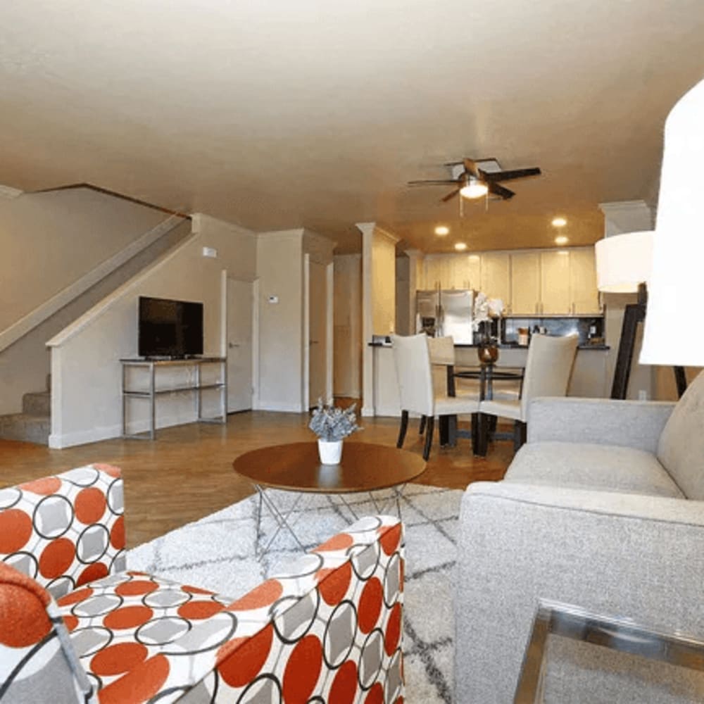 Couch standing on hardwood-style flooring in the livingroom of an apartment home at Quailwood Apartments in Stockton, California