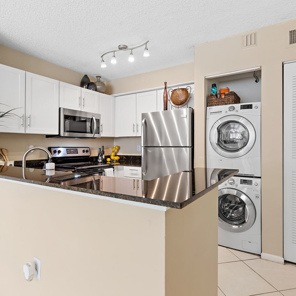 Kitchen with a stacked washer and dryer at Estates at Countryside in Clearwater, Florida