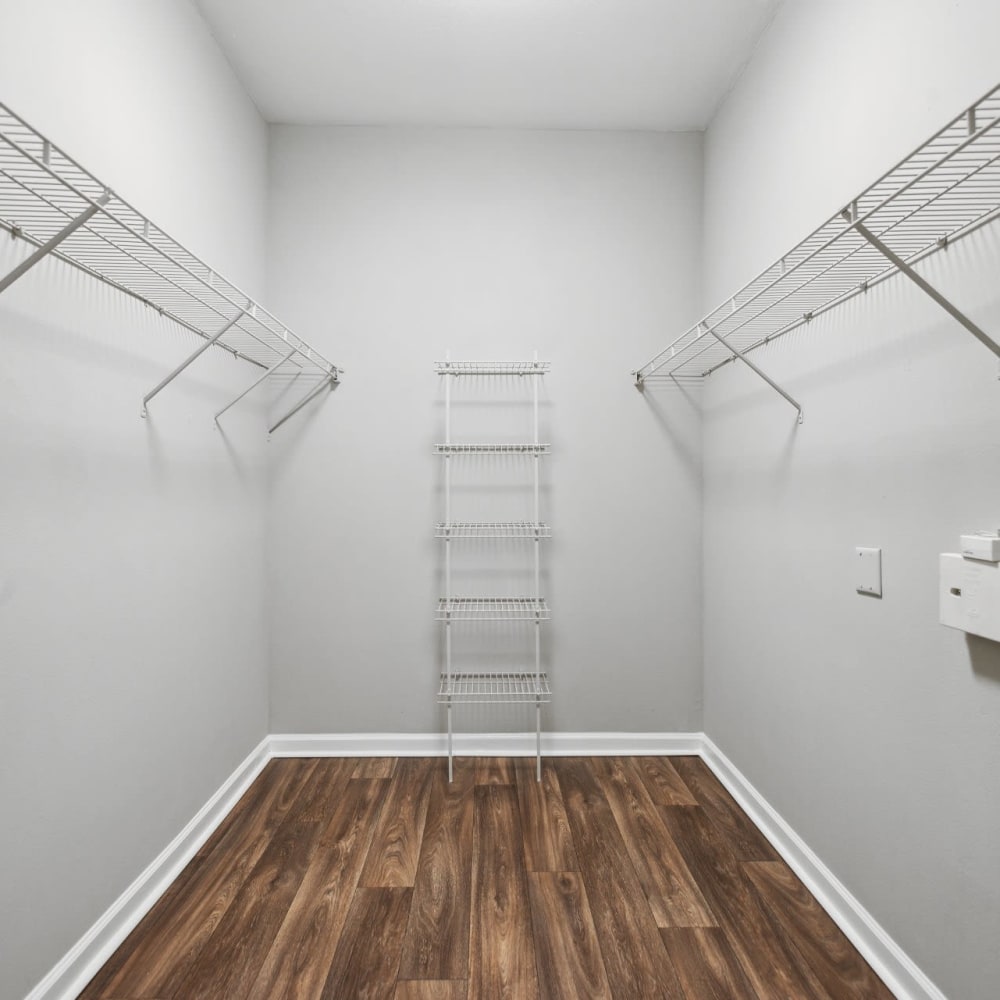 A large walk-in closet in an apartment closet at Discovery at West Road in Houston, Texas