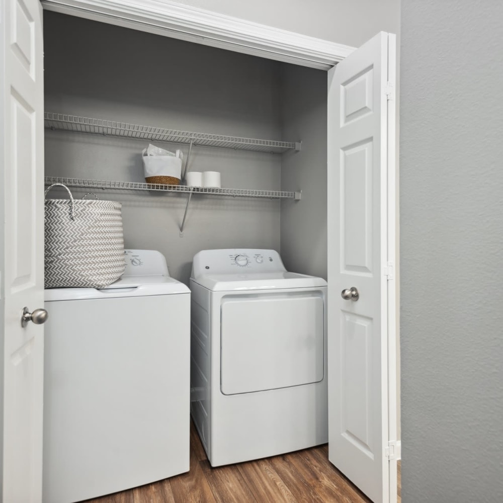 A full-sized washer and dryer in an apartment laundry room at Discovery at West Road in Houston, Texas