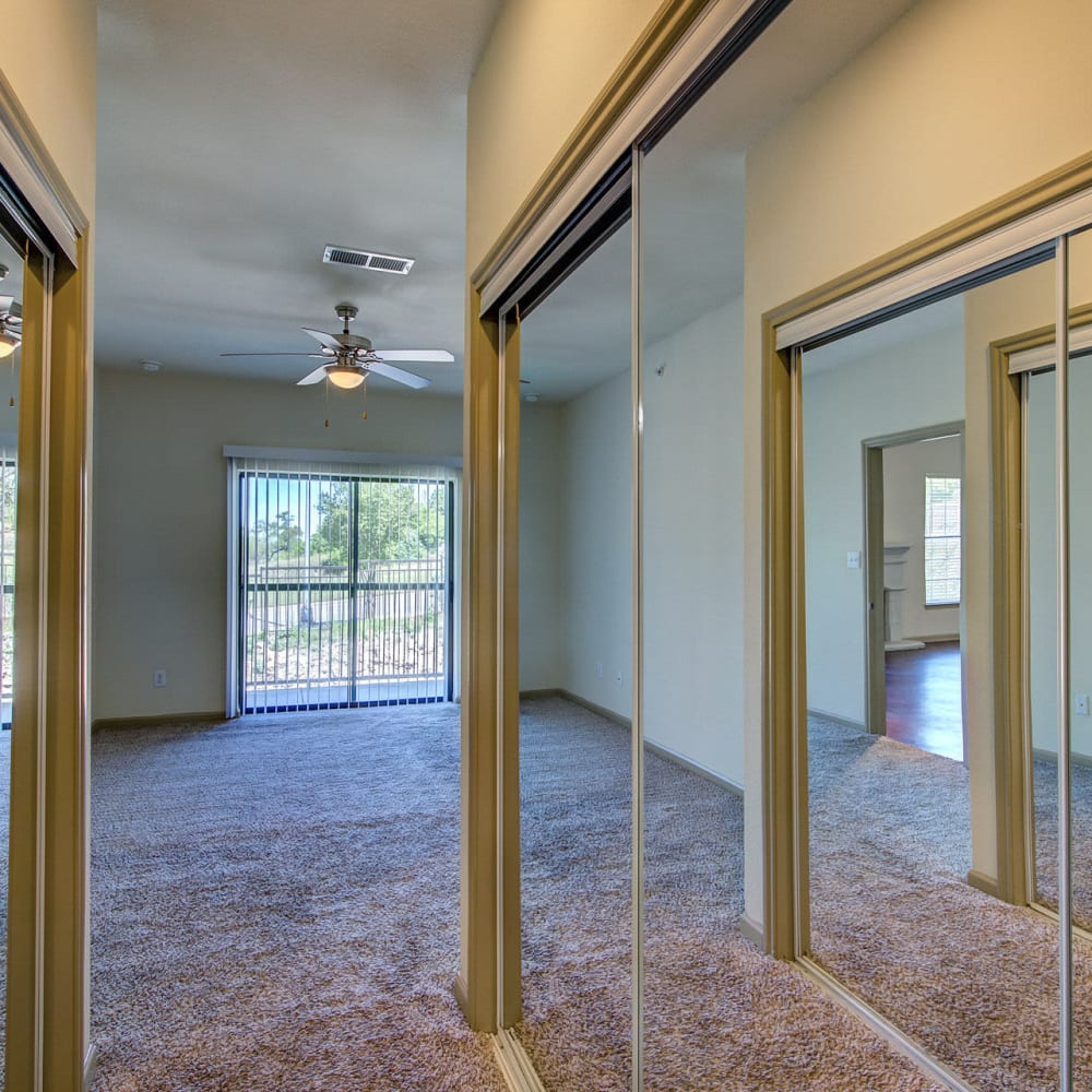 Hallway into a master bedroom lined with mirrors at Estates at Canyon Ridge in San Antonio, Texas 