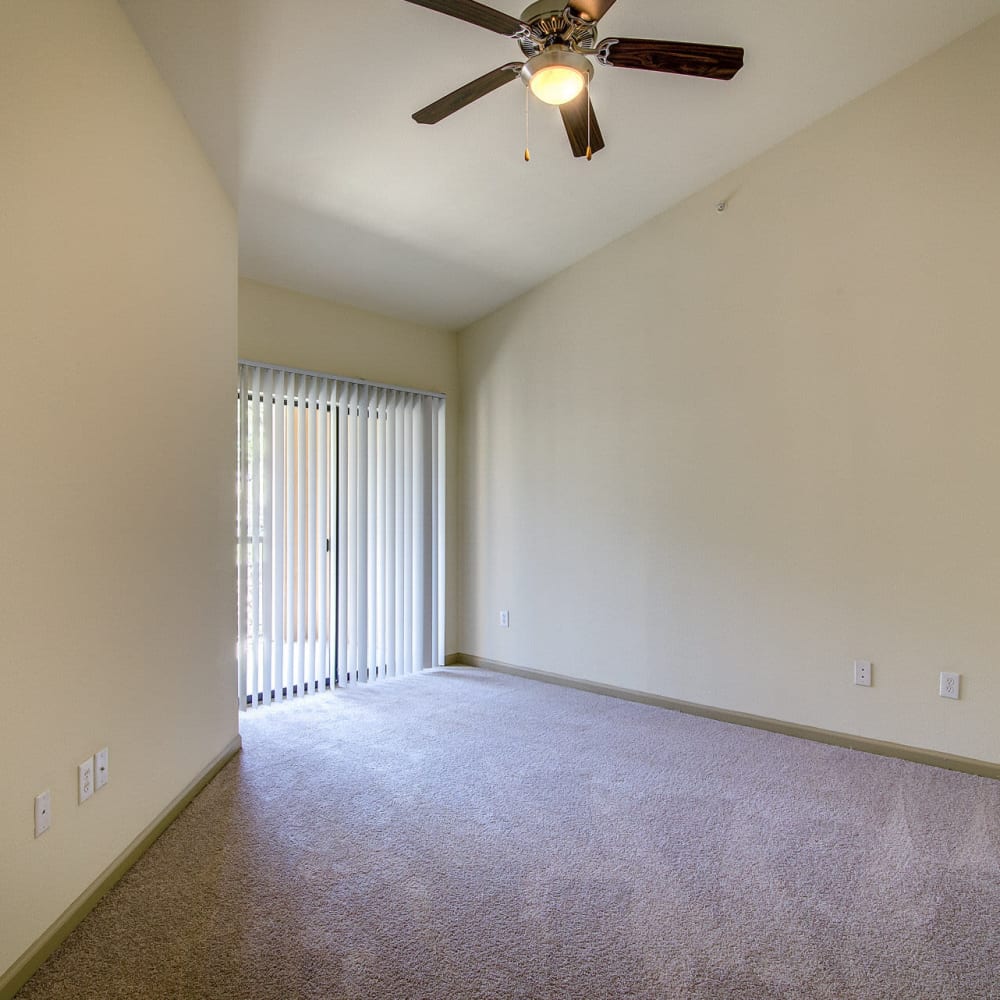 Bedroom with plush carpeting at Estates at Canyon Ridge in San Antonio, Texas