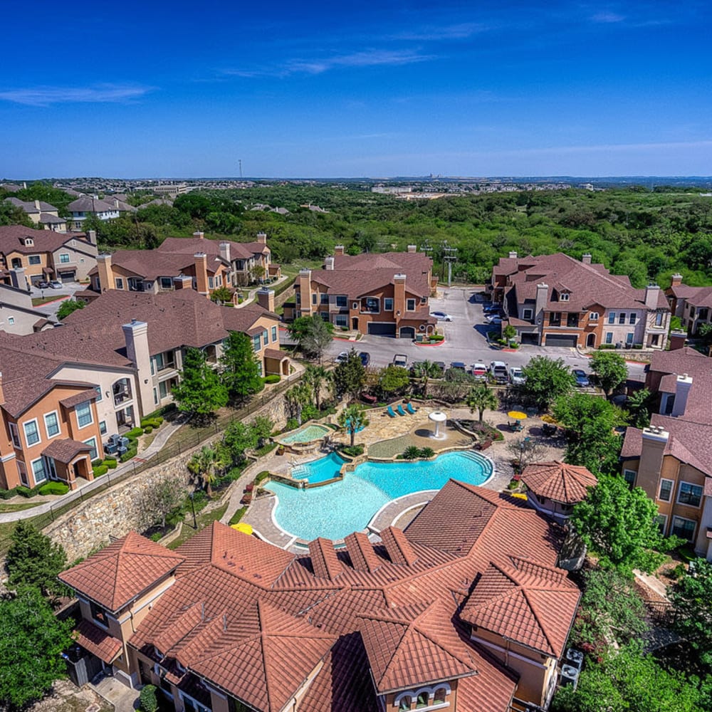 Overhead view showing pools and beautiful community rooftops at Estates at Canyon Ridge in San Antonio, Texas