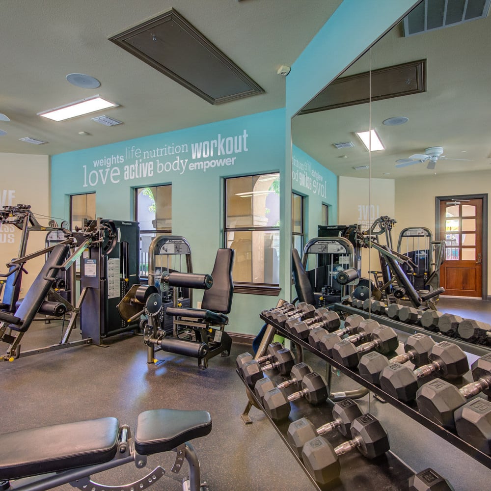 Fitness center with free-weights at Estates at Canyon Ridge in San Antonio, Texas