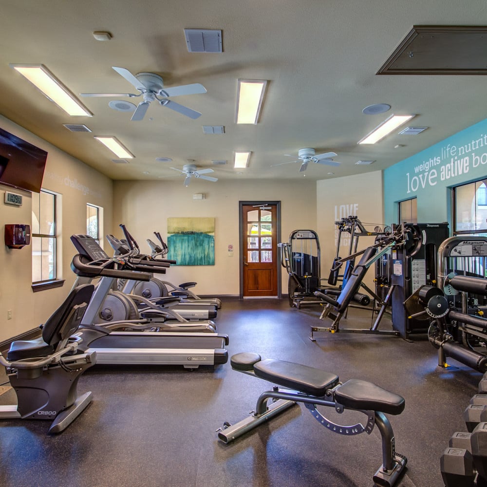 Fitness center with multiple stations at Estates at Canyon Ridge in San Antonio, Texas