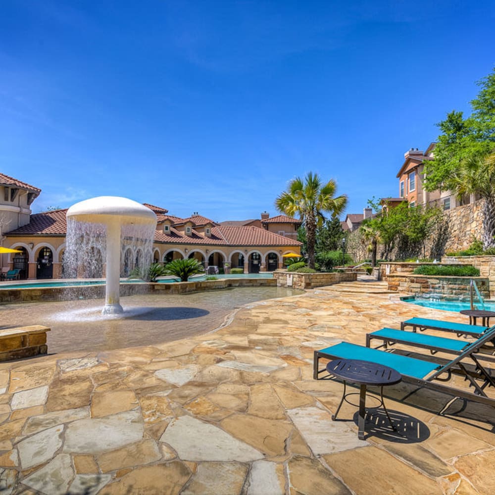 Rock-style patio surrounds the pool at Estates at Canyon Ridge in San Antonio, Texas