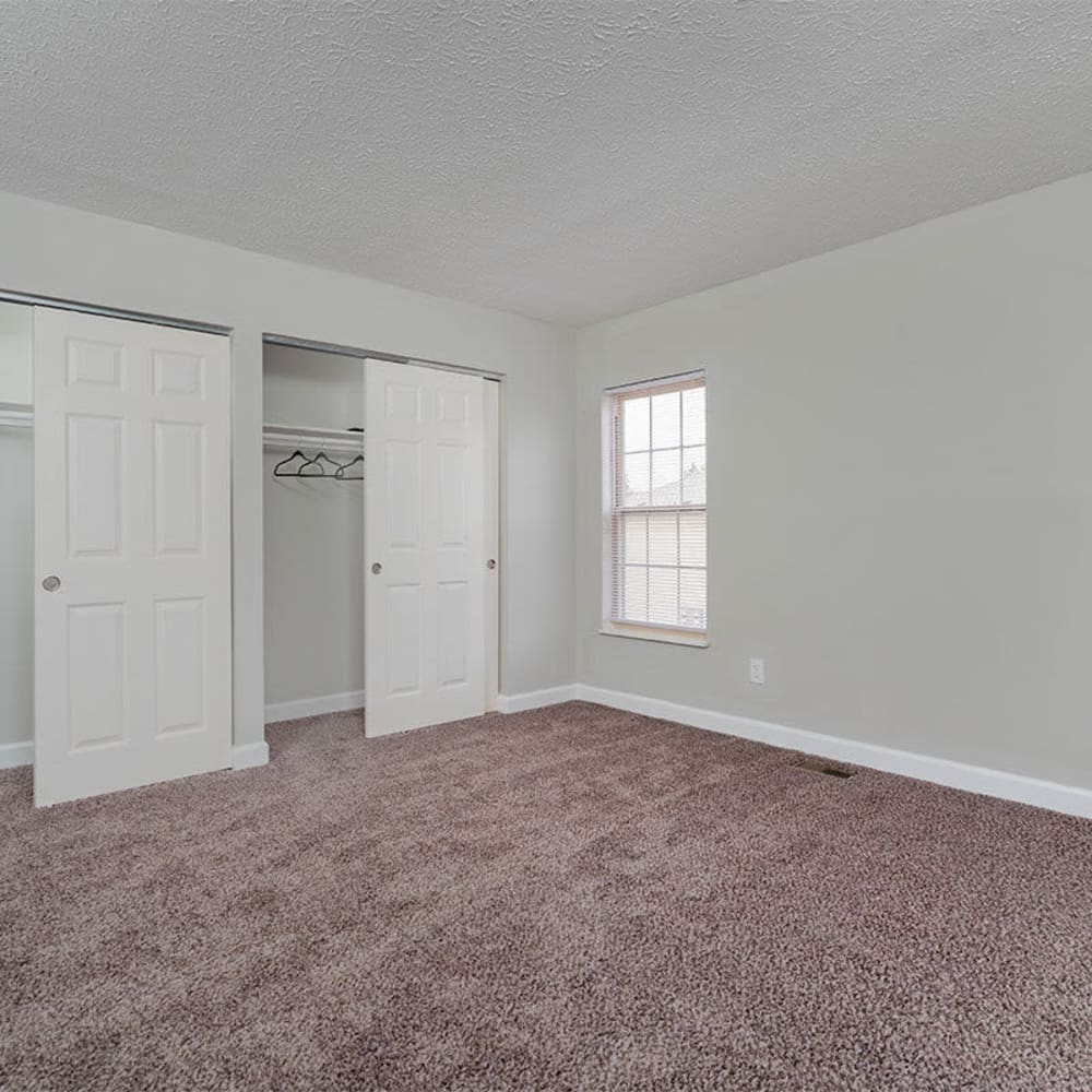 Large bedroom space with plush carpeting at Mason Row Townhomes in Dublin, Ohio