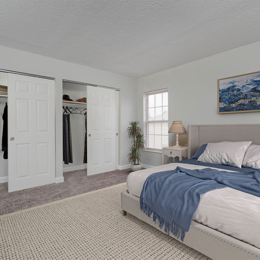 Master bedroom with a rug and a bed at Mason Row Townhomes in Dublin, Ohio