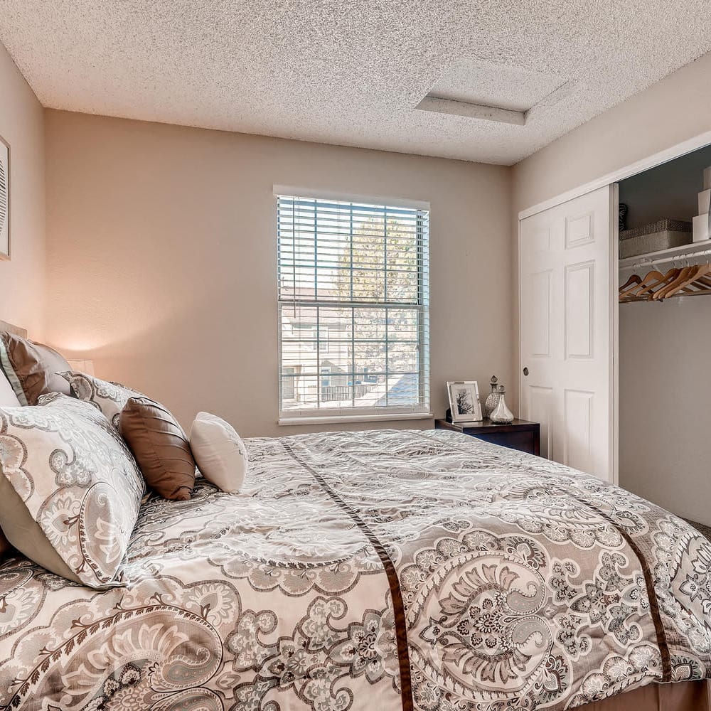 Bedroom with a bed and large closet at Village On Cypress in Thornton, Colorado