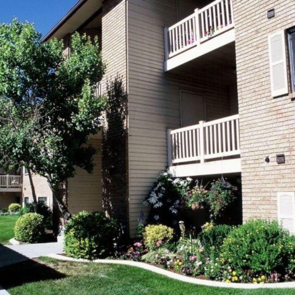 Exterior of apartments and surrounding shrubs at Mallard Crossing Apartments in Millcreek, Utah