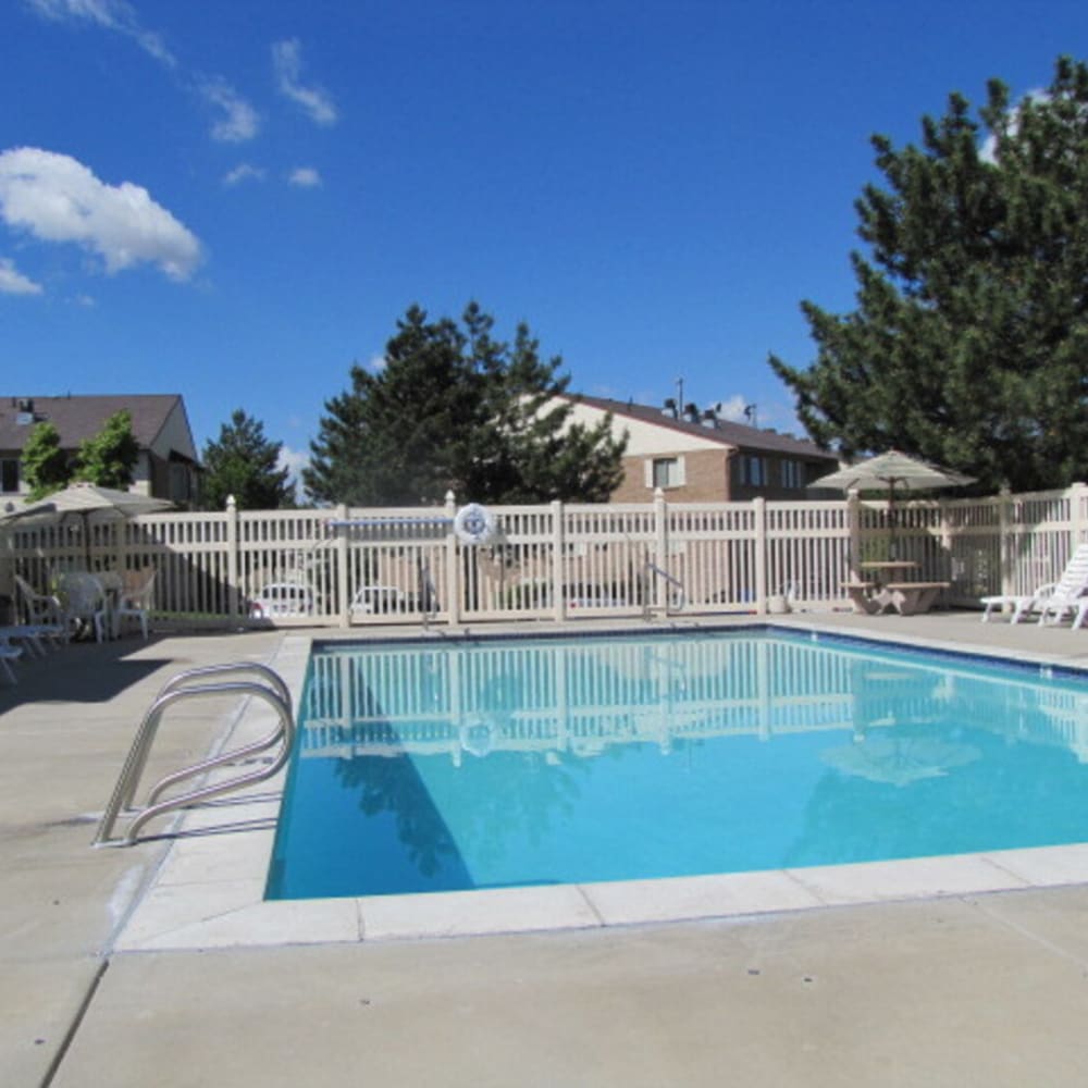 The swimming pool with seating around it at Clinton Towne Center Apartments in Clinton, Utah