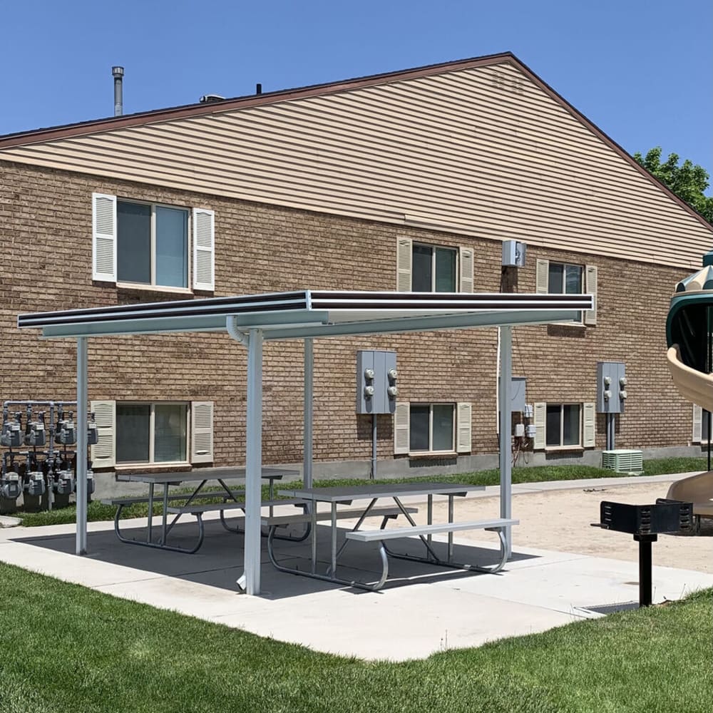 Covered picnic tables for residents at Lincoln Park Apartments in Taylorsville, Utah