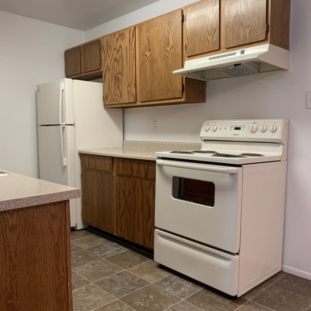White appliances in an apartment kitchen at Lincoln Park Apartments in Taylorsville, Utah