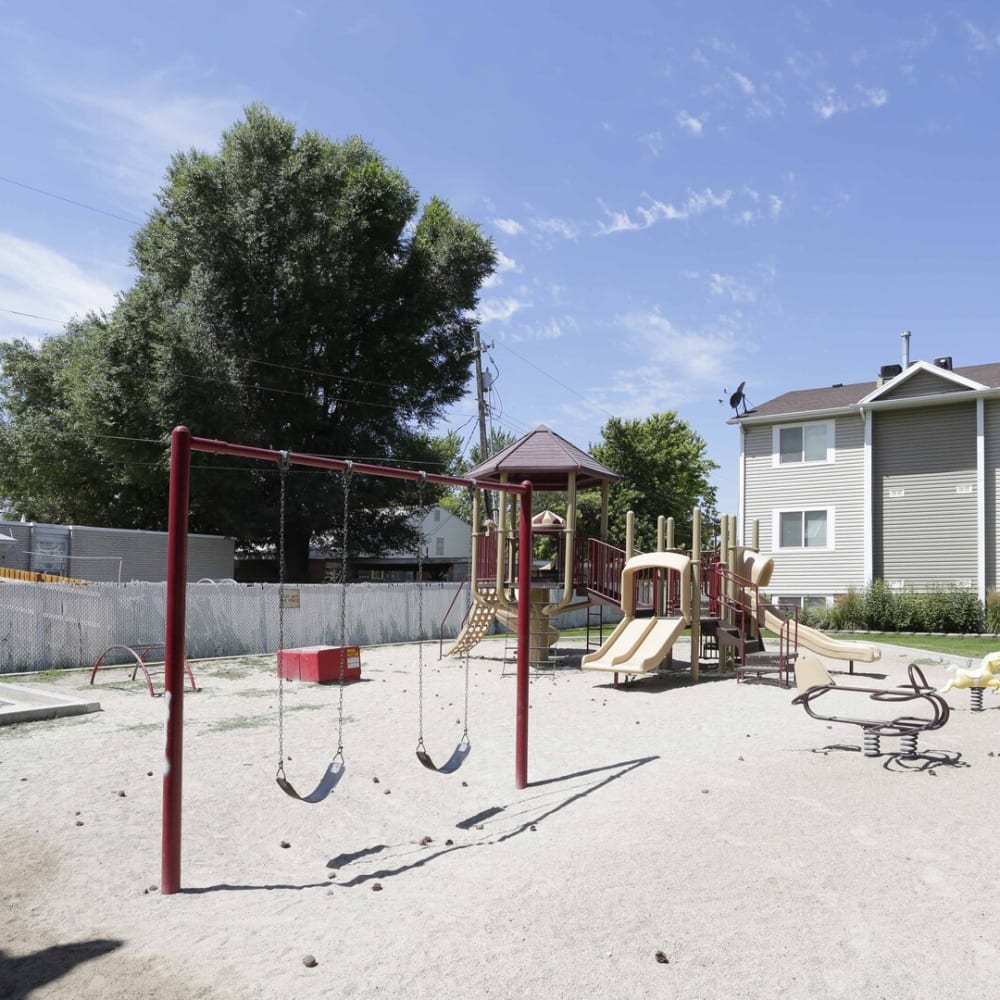 A swing set and playground at Valley Park Apartments in Salt Lake City, Utah