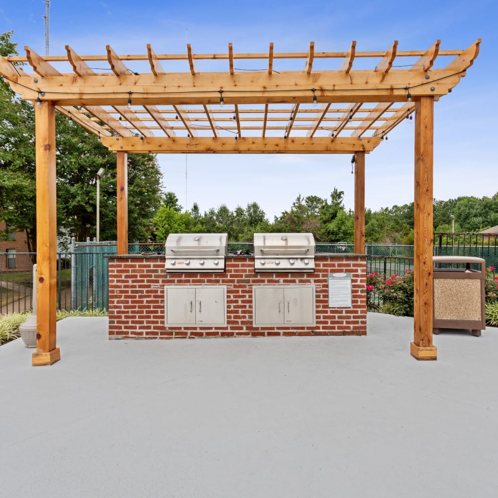 An outdoor grilling area by the pool at Park West End in Richmond, Virginia