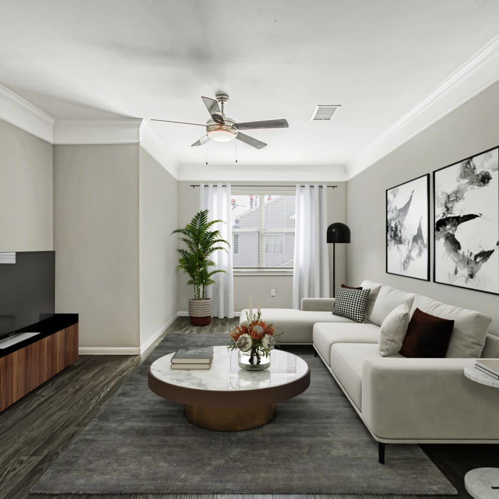 Resident living room with wood-style flooring at Villas at West Road in Houston, Texas