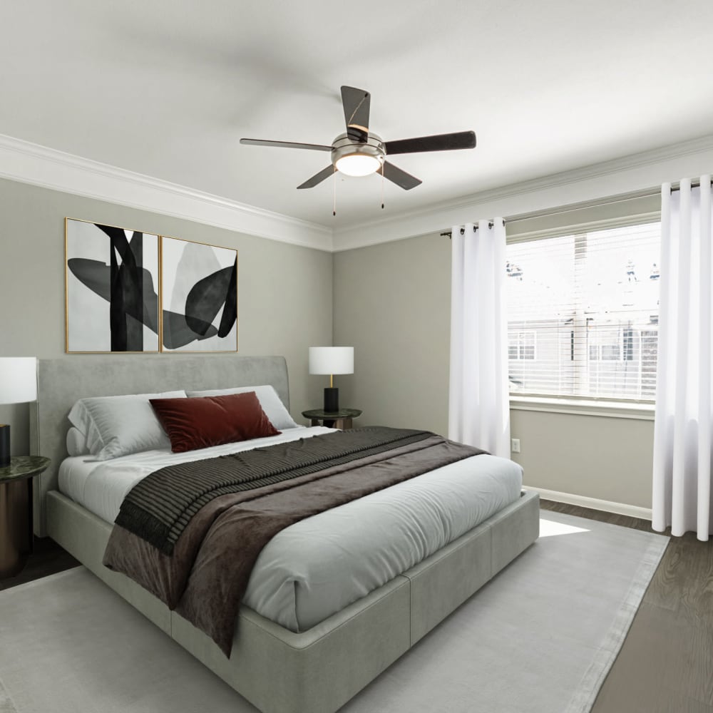 Resident master bedroom with a ceiling fan at Villas at West Road in Houston, Texas