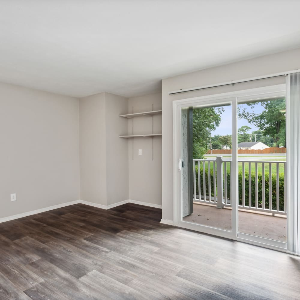 Wood flooring and a sliding door to the patio in a model apartment at Park West End in Richmond, Virginia