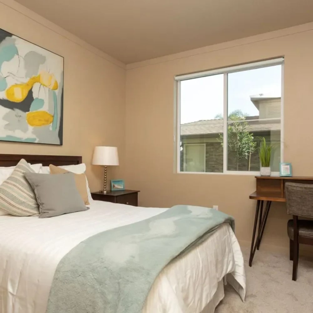 Bedroom with large window at Stonebrier Apartments in Stockton, California