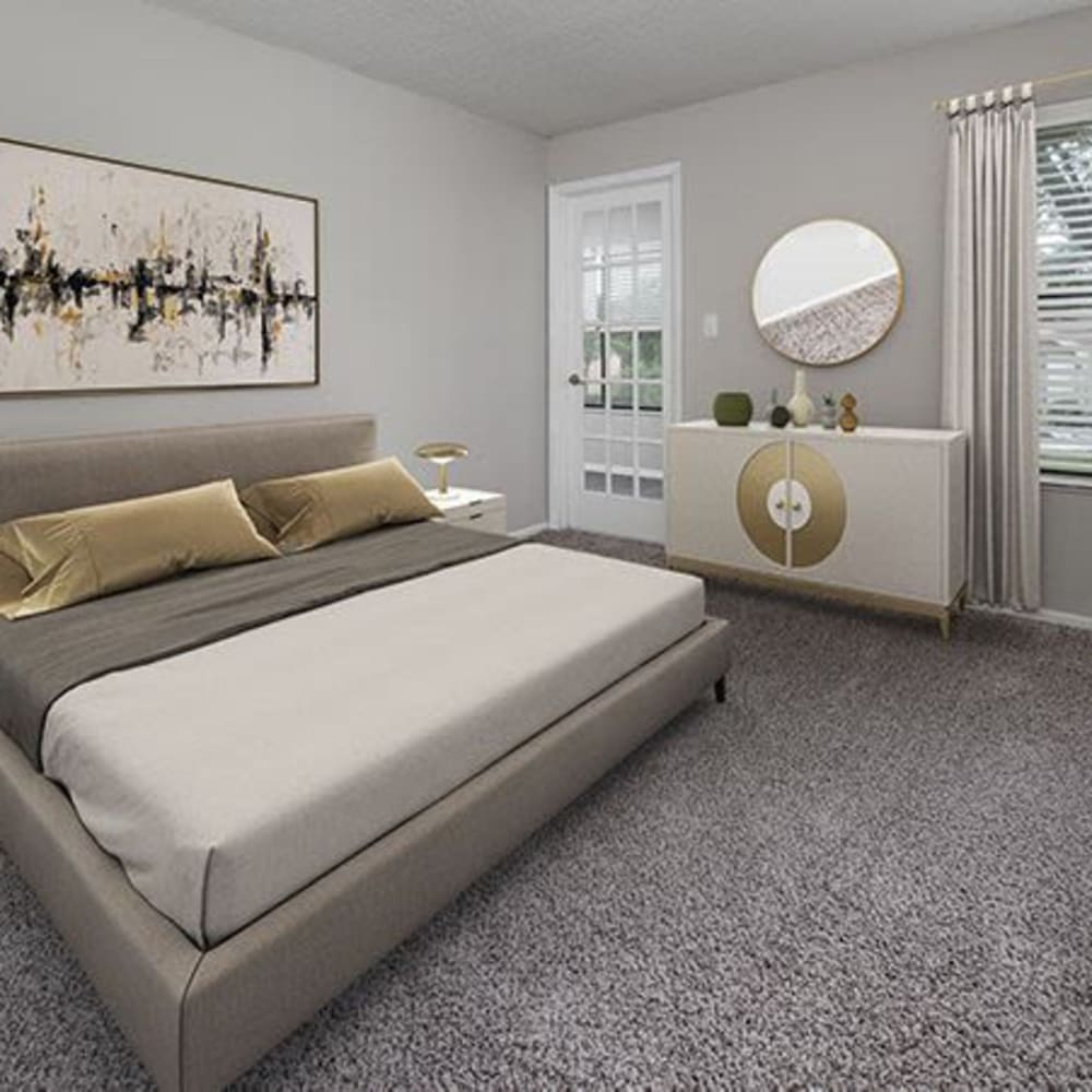 Master bedroom with plush carpeting at The Edge at Lake Lotus in Altamonte Springs, Florida