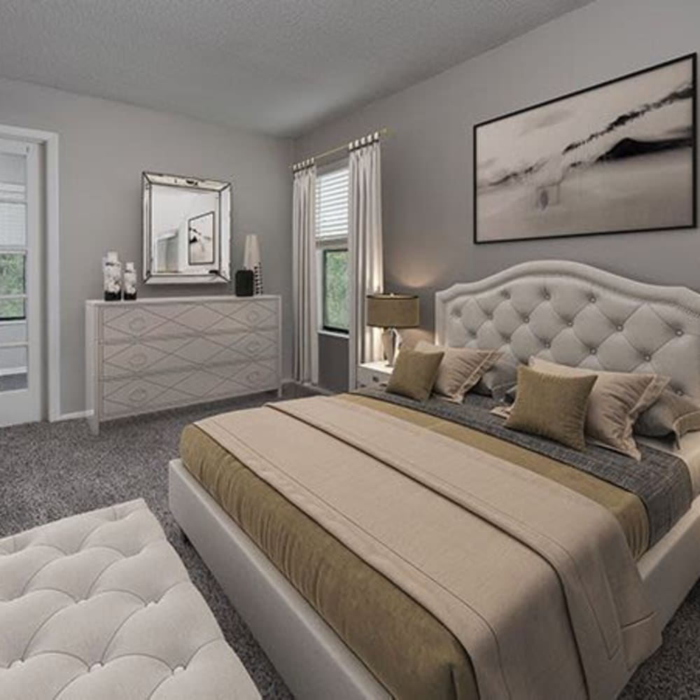 Bedroom with a large bed and ample lighting at The Edge at Lake Lotus in Altamonte Springs, Florida